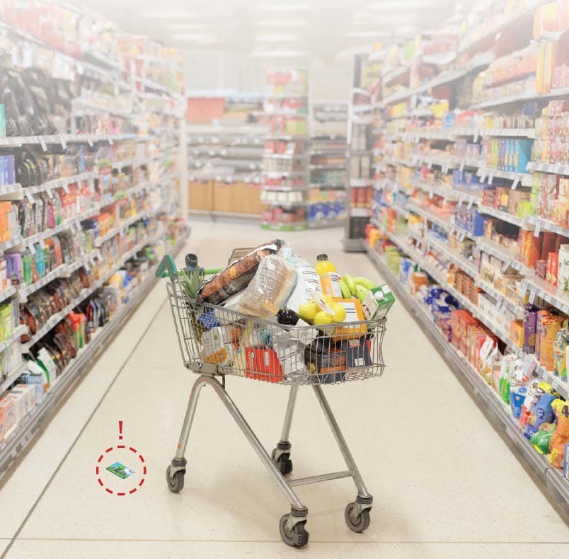 eWIC card on floor of grocery store next to a shopping cart