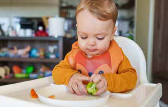 Baby eating vegetables