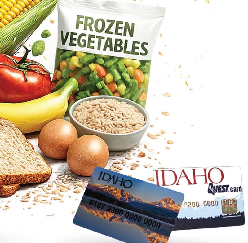 Assorted foods with two Idaho benefit cards displayed in front.