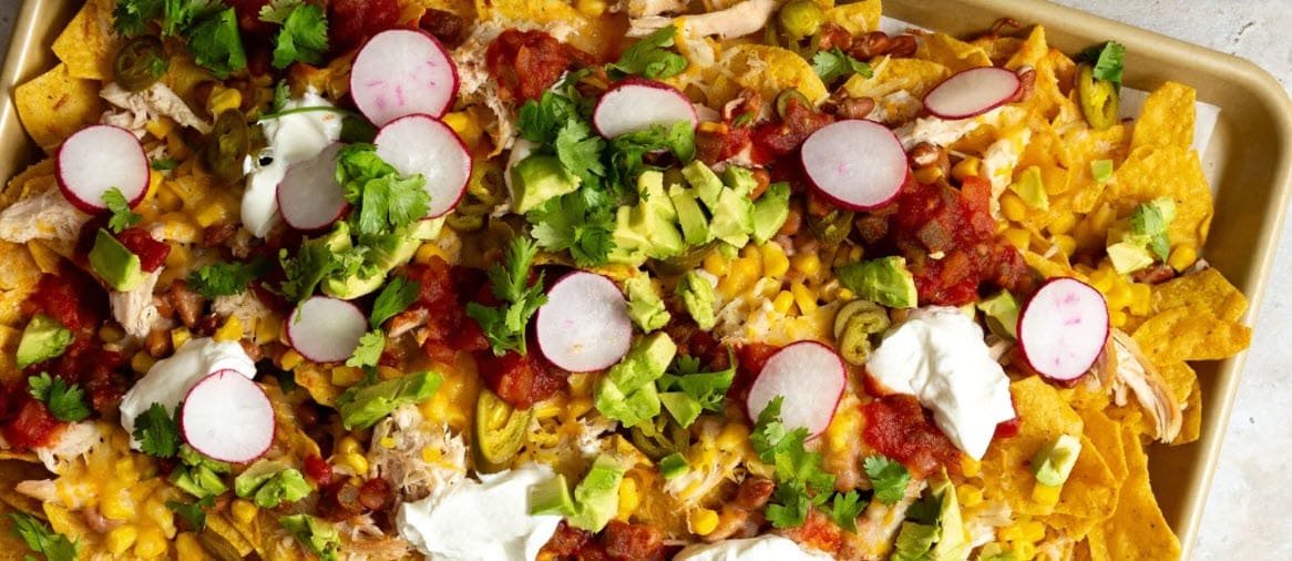 Weeknight Rotisserie Chicken & Loaded Veggie Nachos on a pan