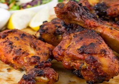 Tandoori chicken with lemon on a plate